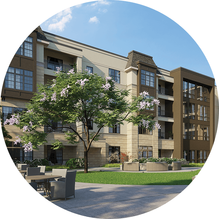 Exterior view of Searstone Retirement Community featuring a blossoming tree