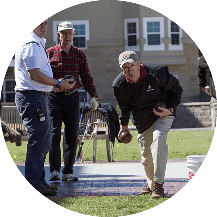 Senior men playing bocce ball at Searstone