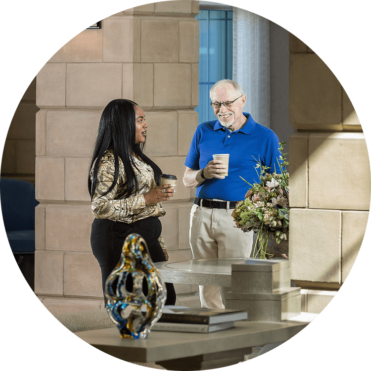 Senior man speaking with woman at Searstone