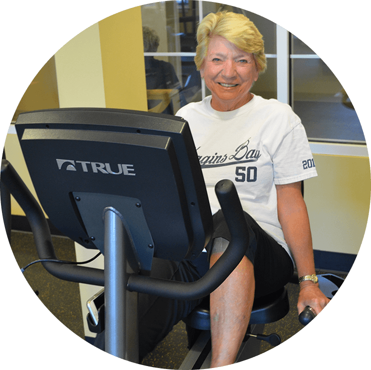 Active senior woman taking care of her health and wellness at the gym