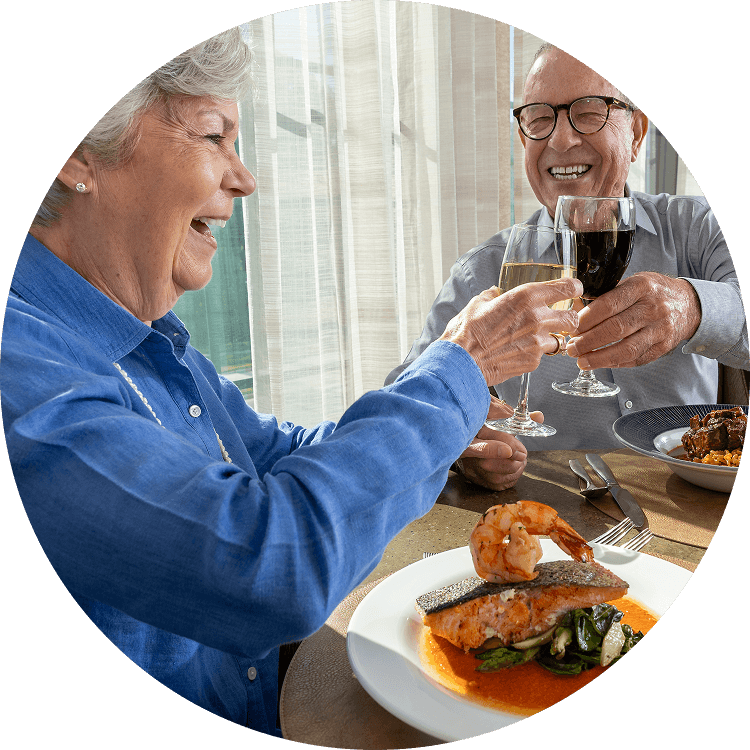 Senior couple enjoying dinner at a senior living community