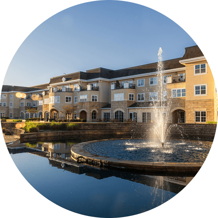 Exterior view of Searstone Retirement Community featuring a water fountain