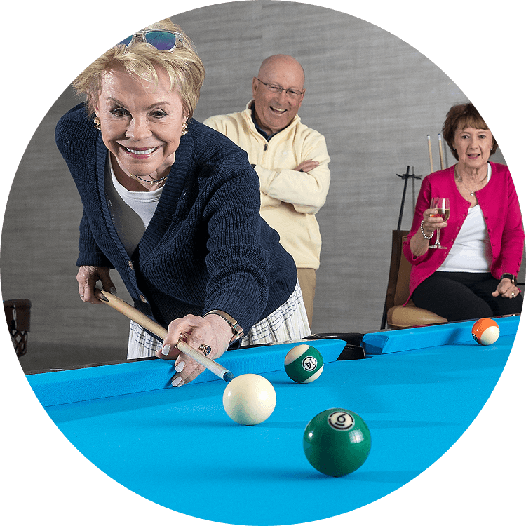 Elderly adults playing billards at a life plan community