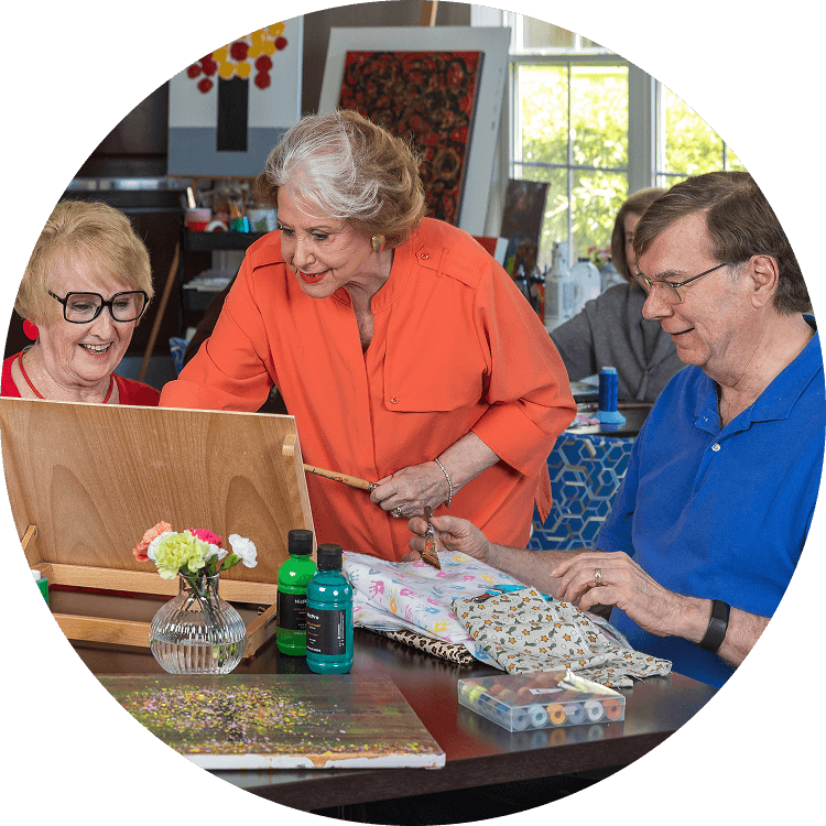 Elderly adults crafting in a communal space at Searstone Retirement Community