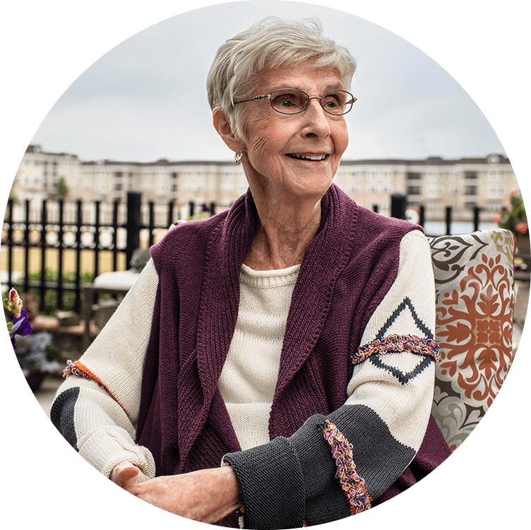 Senior woman smiling outside of Searstone, a life plan community in North Carolina