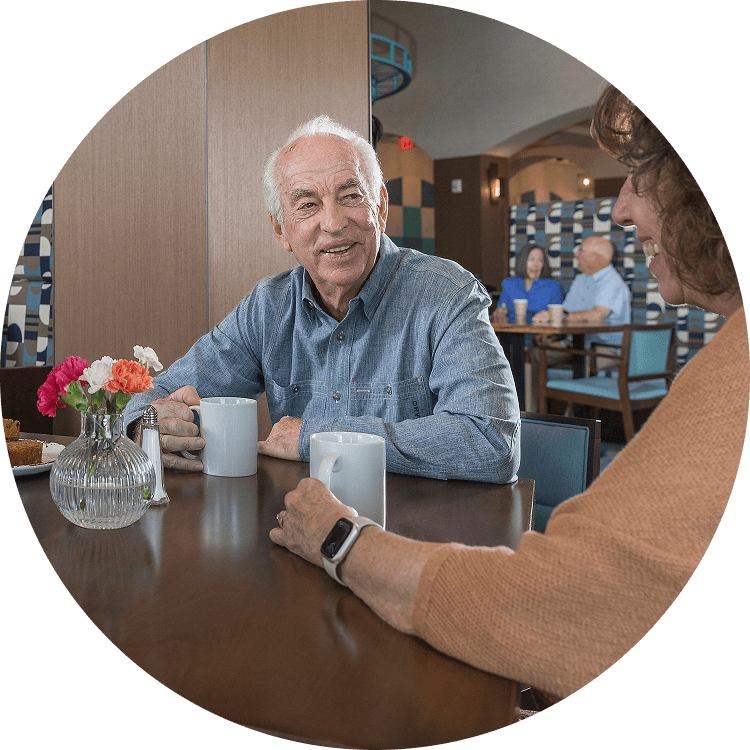 Elderly couple enjoying coffee and breakfast at Searstone