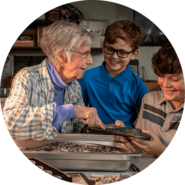 Grandmother showing her grandchildren a project she has been working on