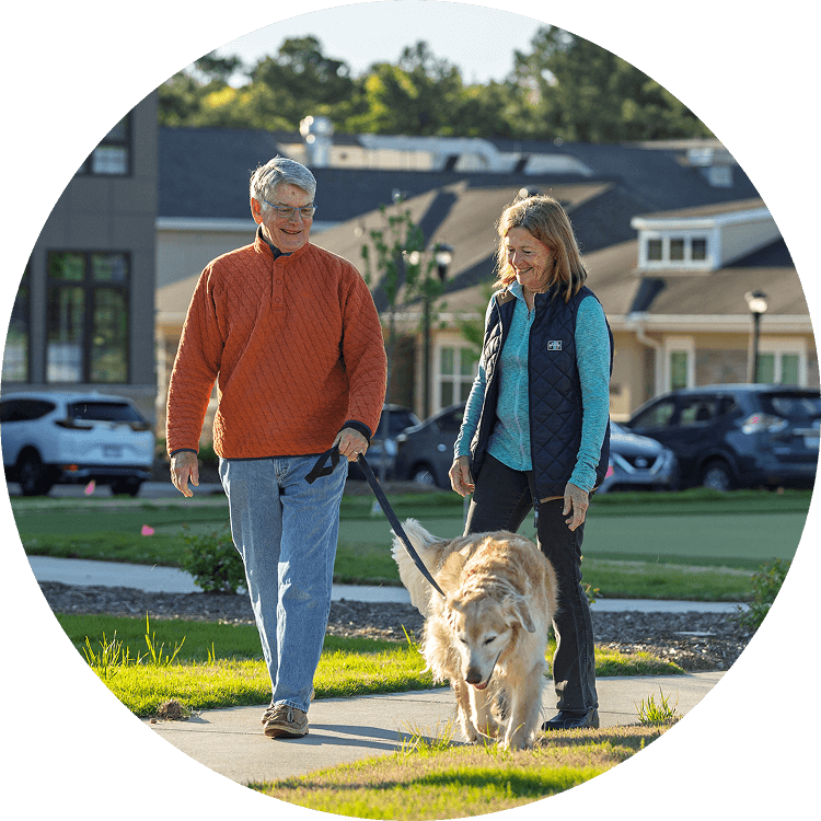 Senior couple walking their dog on the Searstone property