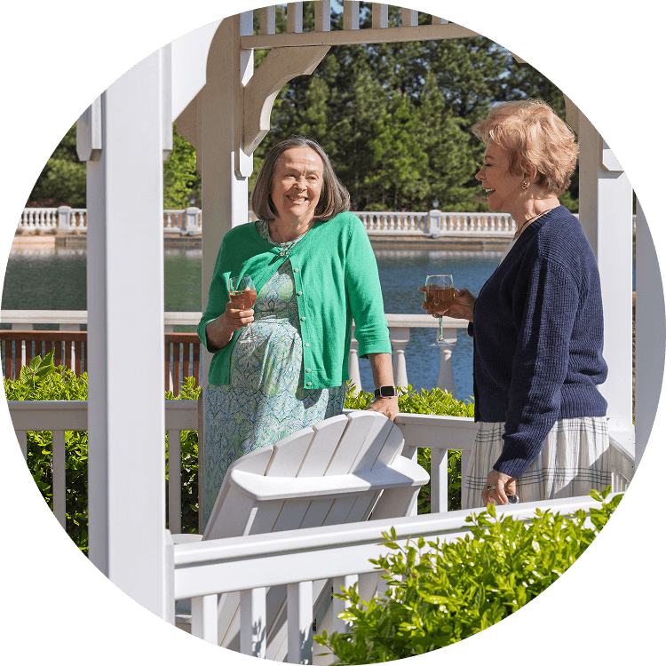 Senior women enjoying a glass of wine outside on the Searstone property