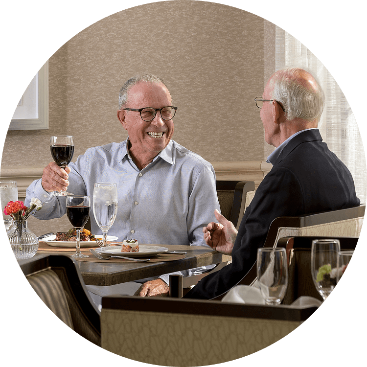 Senior men enjoy dining at a life plan community in NC