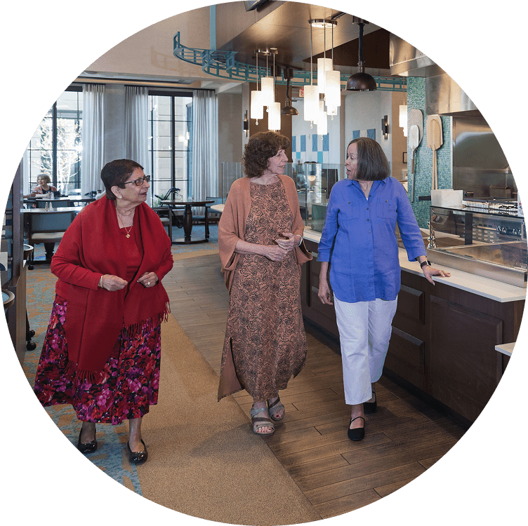 senior women socializing in a dining hall at Searstone