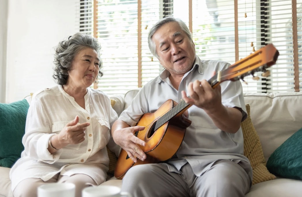 Senior couple enjoying music time together at home